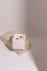 scented candles on off white background in rock holder