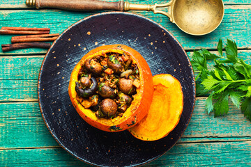 Tasty autumn stuffed pumpkin with mushrooms