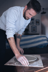 Man in lounge making ceramics