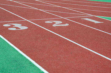 The numbers 1,2,3 on the running track. Red jogging tracks at th