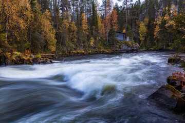 Beautiful autumn landscape with the river and old building, Oulanka National park, Finland