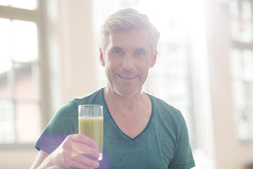 Older man drinking glass of juice