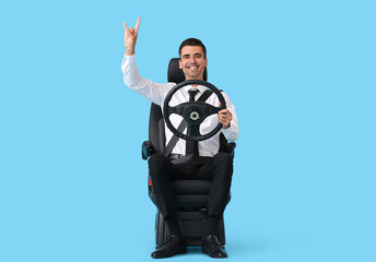 Businessman in car seat and with steering wheel showing 