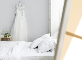 Mirror with reflection of beautiful wedding dress in bedroom