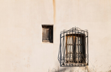Two windows on white wall in small town of South of Spain