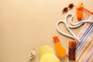 Set of beach accessories for children, bottles of sunscreen and seashell on color background,...