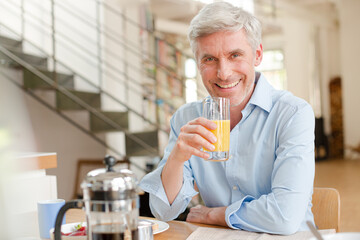 Older man drinking glass of juice