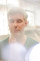Fototapeta na wymiar Close up of older man meditating