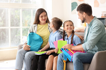 Parents getting their little children ready for school