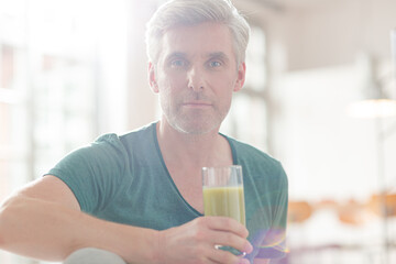 Older man drinking glass of juice