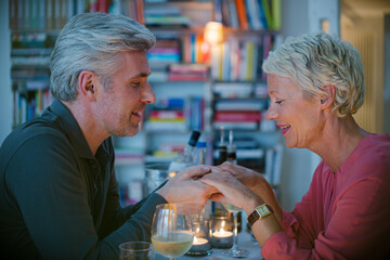 Close up of romantic older couple holding hands