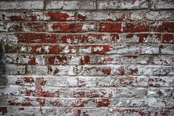 Old red brick wall texture photo background. White paint peeling