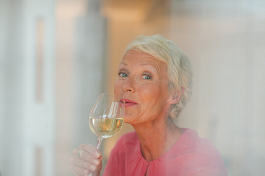 Older Woman Drinking Glass Of White Wine