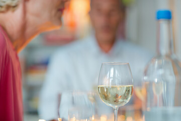 Older romantic couple drinking white wine