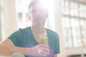 Older man drinking glass of juice