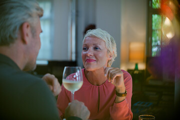 Older romantic couple drinking white wine