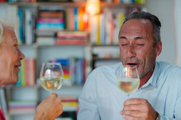 Older friends drinking white wine