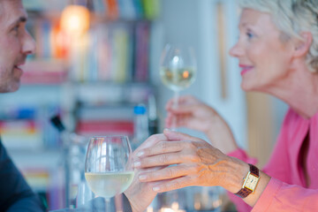 Close up of romantic older couple holding hands