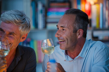 Older friends tasting white wine