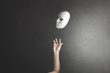 person throws the mask he wore into the air to get rid of it - obrazy, fototapety, plakaty
