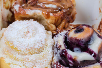 Cakes with different sprinklings as street food, fragment close-up