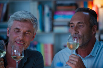 Older friends tasting white wine