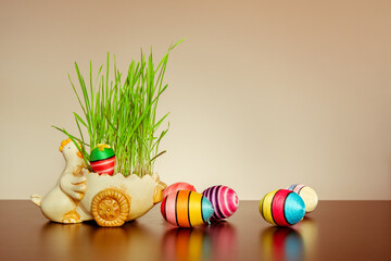 Easter decorations, sown grain in a pot with colorful handmade Easter eggs.
