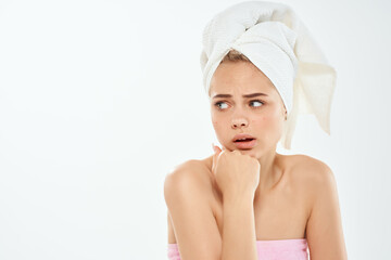 woman with a towel on her head bare shoulders close-up clean skin