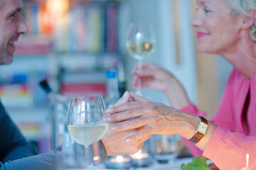 Close up of romantic older couple holding hands
