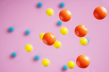 Colorful balls flowing upwards on pink background. .Abstract background with bright balls.