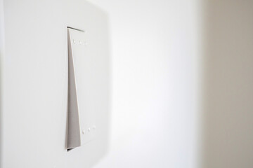 white lighting switch on concrete wall