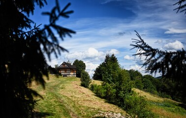 Clouds over the vilage house in Ochotnica Gorna vilage during summer day