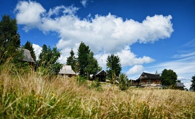 Fototapeta na wymiar Clouds over the Ochotnica Gorna vilage hills during summer day