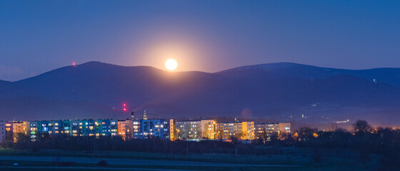 Bystrzyca Klodzka by night, moonrise against the Sudety mountain peaks.