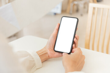 cell phone blank white screen mockup.woman hand holding texting using mobile on desk at office.background empty space for advertise.work people contact marketing business,technology