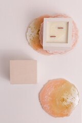 scented candles on off white background in rock holder