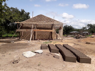 school building under construction in an undeveloped country in Africa. Developing countries and relief work context. School for african children.