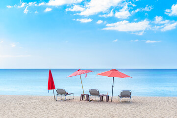 Beach chairs with umbrella and sand beach in summer beach and tropical sea.