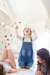 Obraz premium Three teenage girls playing on bed in bedroom