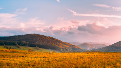 Bystrzyca Klodzka, mountain landscape, a view of the Bystrzyckie Mountains and farmland before sunset.