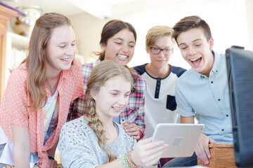 Group of teenagers taking selfie with digital tablet