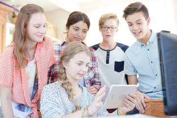 Group of teenagers taking selfie with digital tablet