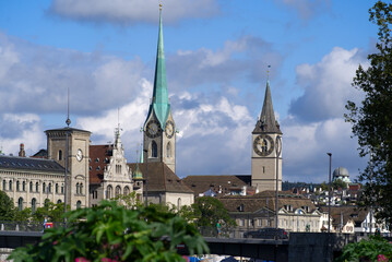 Fototapeta na wymiar Protestant churches St. Peter and Fraumünster (Womens's Minster) at the old town of Zurich at a beautiful cloudy summer day. Photo taken August 27th, 2021, Zurich, Switzerland.