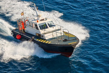 Pilot vessel operating on the sea. Harbor maritime control. Nautical