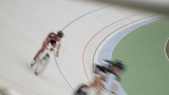 Track cycling team riding in velodrome. Track bicycle race on open cycling track