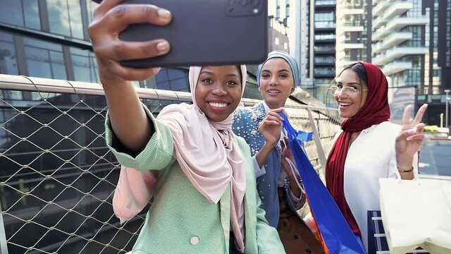 Arabian friends with hijab spending time in the city center