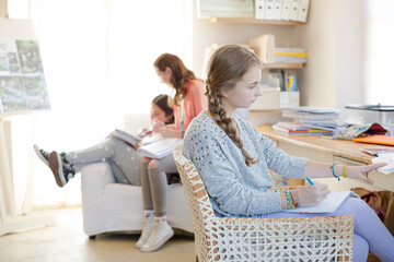 Fototapeta na wymiar Three teenage girls doing homework in room