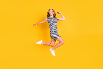 Fototapeta na wymiar Full length profile portrait of cheerful pupil hurry fast have good mood look camera isolated on yellow color background