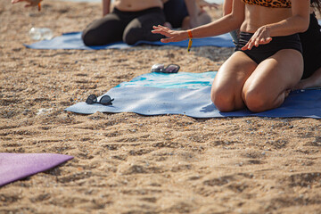 background with women doing yoga on the beach , active lifestyle