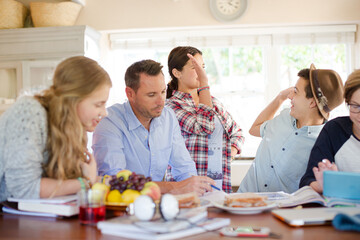 Group of teenagers doing high five in living room